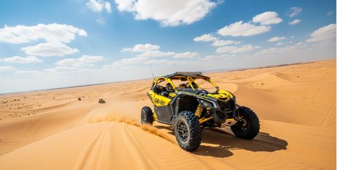 Can-Am Maverick X3 buggy speeding through the Dubai desert dunes during an adventurous off-road tour - Can-Am Maverick X3 Buggy Tours in Dubai